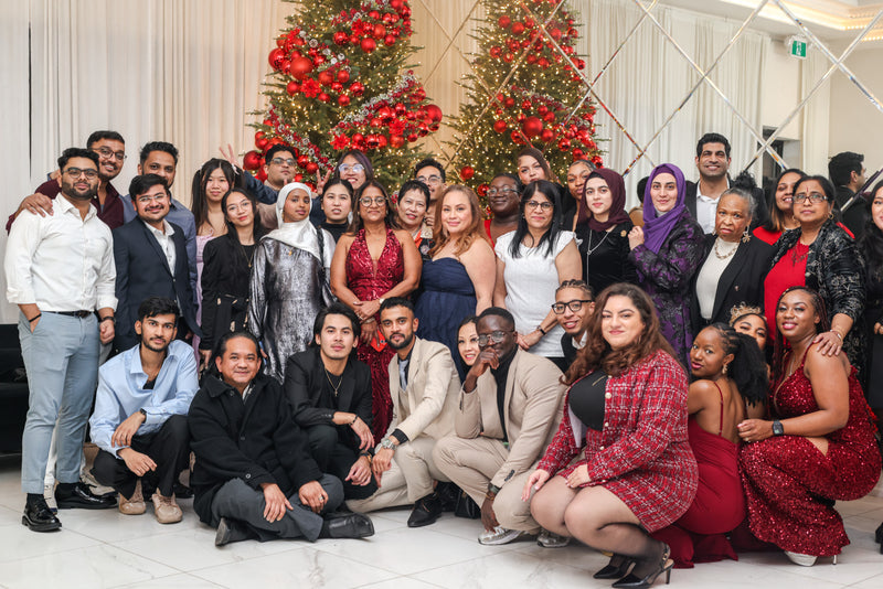Group portrait of the Shoppers Drug Mart staff celebrating their Christmas banquet, showcasing event photography by Memoirs Photography.